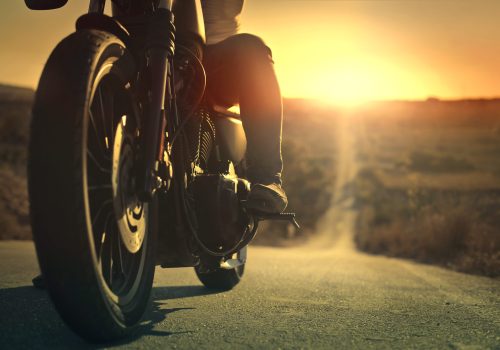 On a roaring motorcycle at sunset